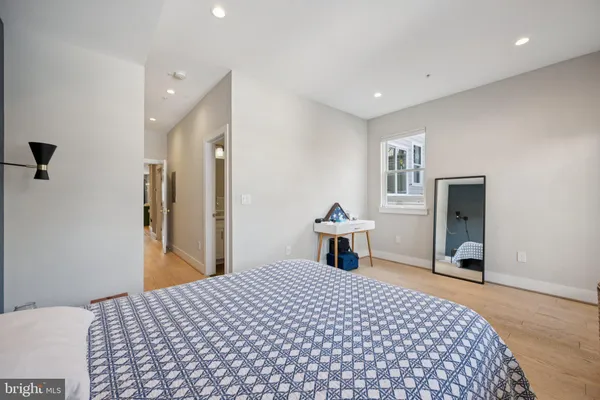 a bedroom with a bed and a dresser