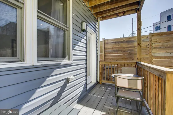 a view of a house with a yard and furniture