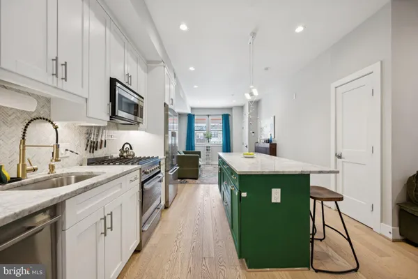 a kitchen with a sink stove and cabinets