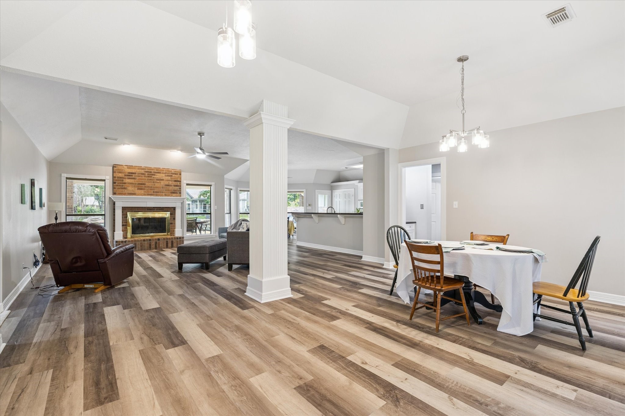 23818 Pin Oak Drive Spring, TX 77389 - Photo 11 of 31 Spacious and light-filled living area with open sightlines to the front dining space and entry, offering a seamless flow for gatherings.