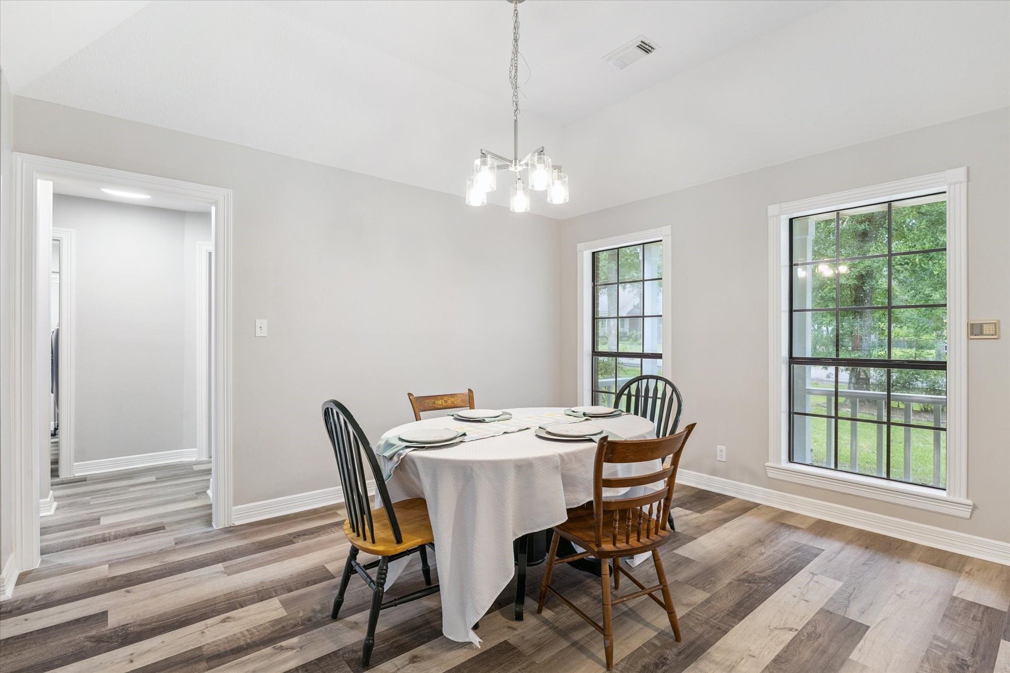 23818 Pin Oak Drive Spring, TX 77389 - Photo 12 of 31 Another look at the dining area featuring fresh neutral tones, clean lines, and new flooring that extends throughout the home.