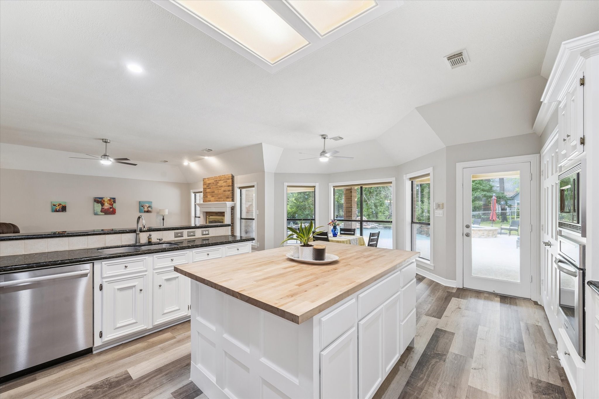 23818 Pin Oak Drive Spring, TX 77389 - Photo 16 of 31 Enjoy cooking while overlooking the family room and pool—this kitchen offers functionality, style, and great natural light.