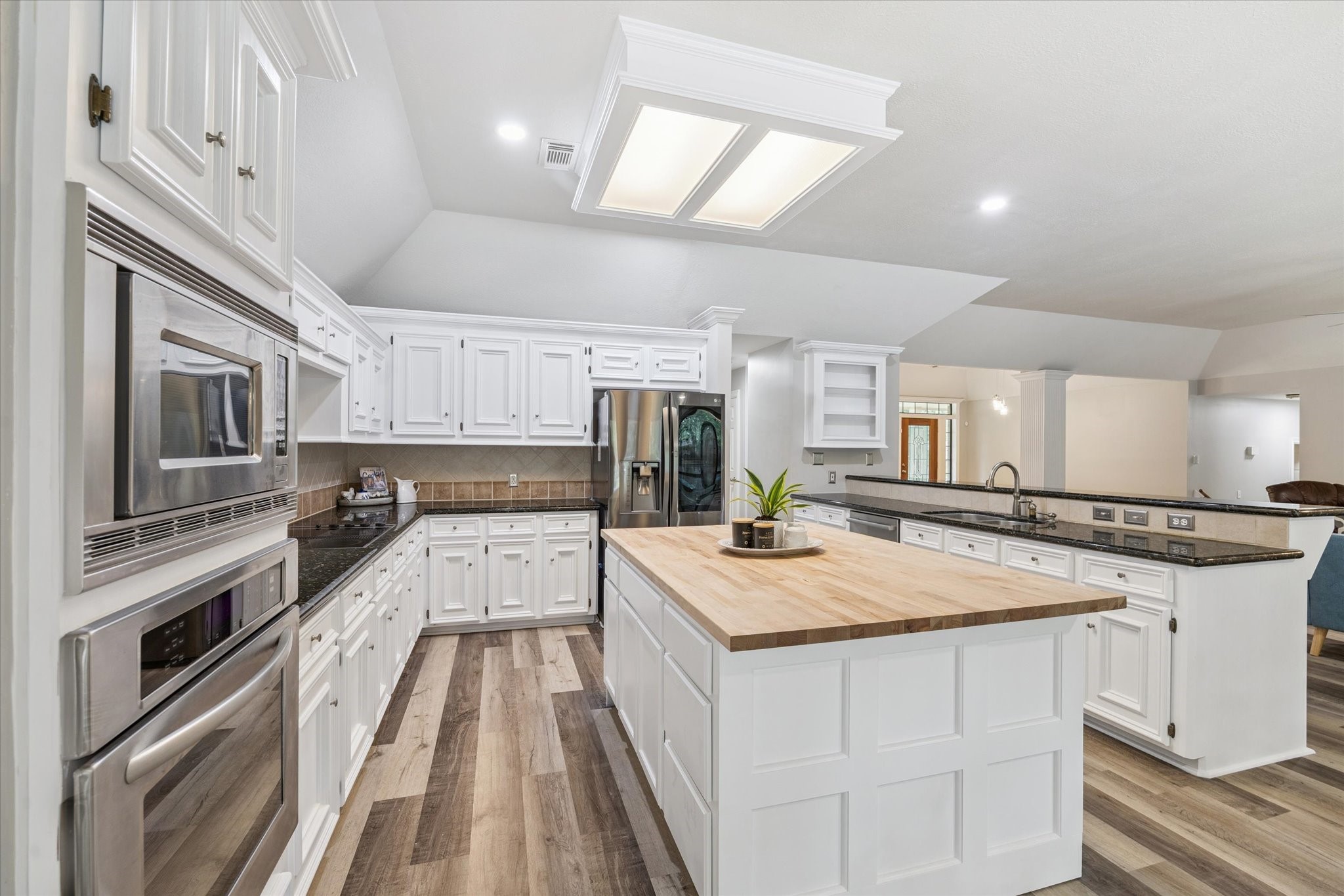 23818 Pin Oak Drive Spring, TX 77389 - Photo 17 of 31 A chef’s dream with extensive cabinetry, stainless appliances, and a layout that opens to both the living area and front entry for easy movement and conversation.