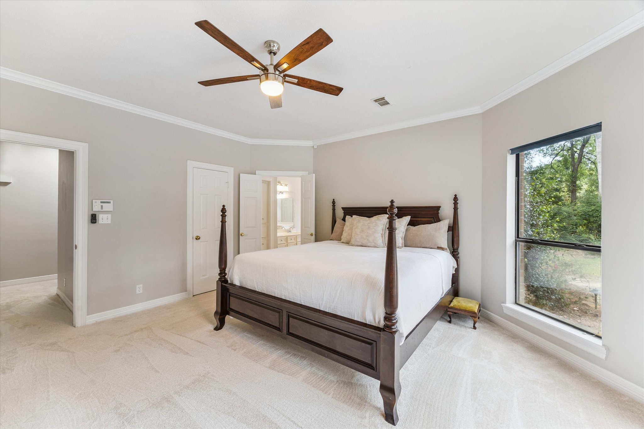 23818 Pin Oak Drive Spring, TX 77389 - Photo 24 of 31 Spacious and stylish primary suite with crown molding, neutral tones, and room for a seating area or reading nook.