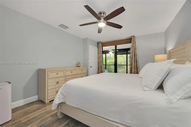 a bedroom with a large bed and a large window