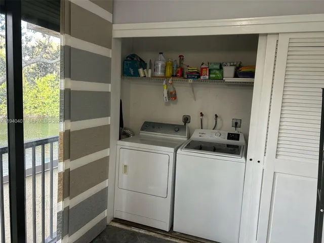a view of storage and utility room with washer and dryer