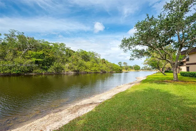 a view of a lake with houses in the back