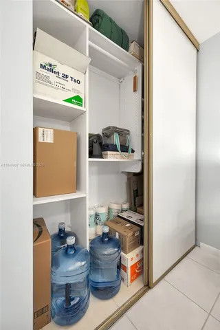 a room with a refrigerator and cabinets