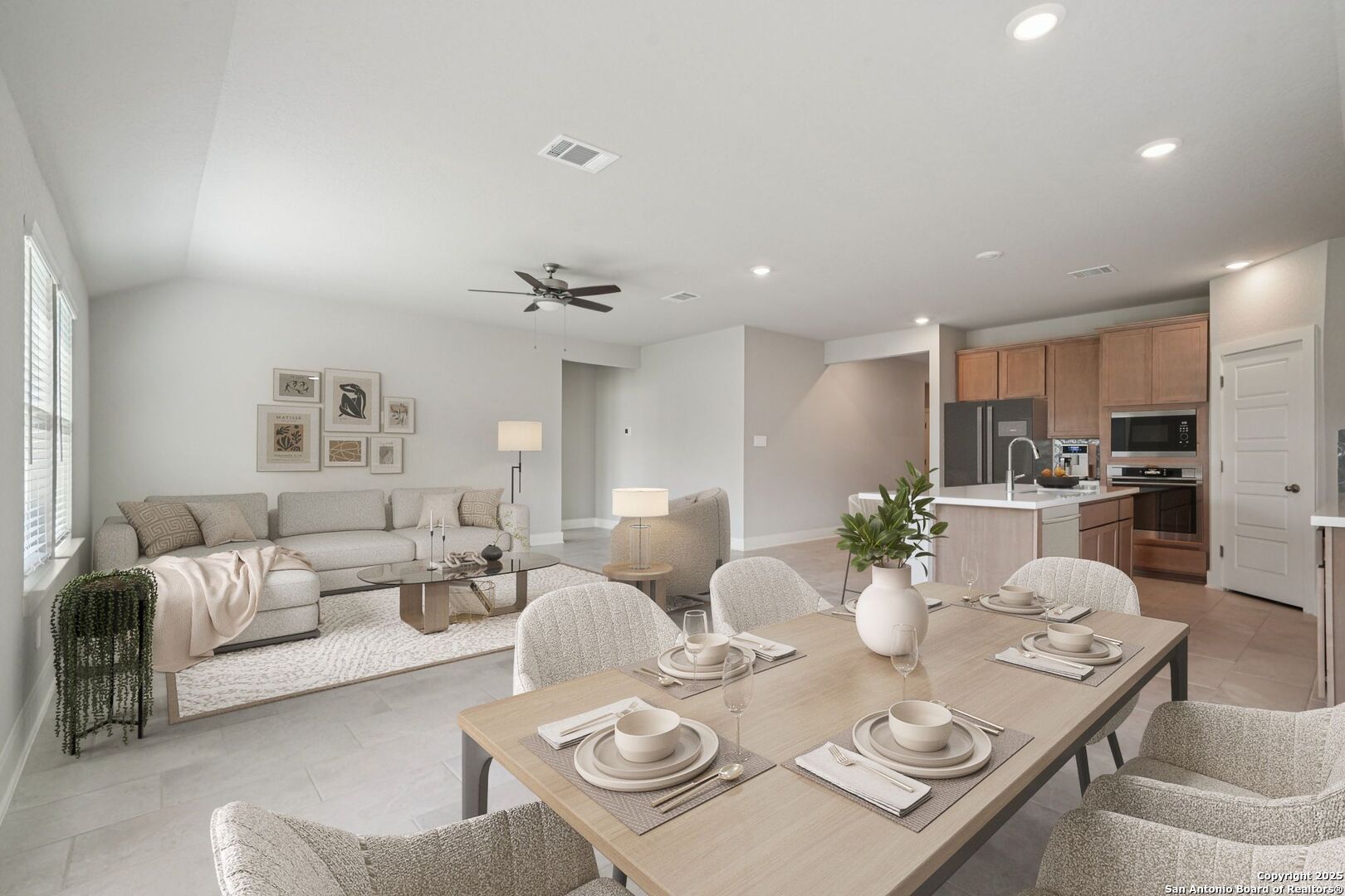 a living room with furniture kitchen and a table