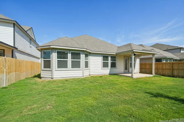 a view of a house with a yard and sitting area