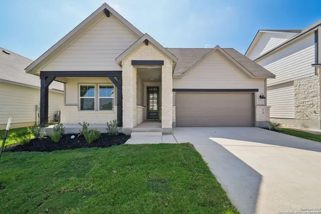 a front view of a house with a garden and plants