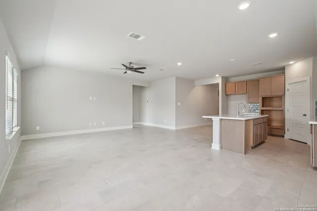 a view of a kitchen with a sink and white cabinets