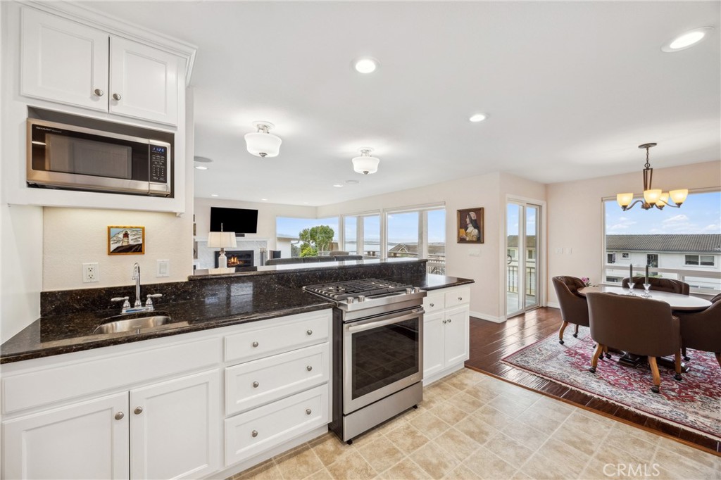 280 Kern Avenue Morro Bay, CA 93442 - Photo 22 of 54 a kitchen with stainless steel appliances granite countertop a stove a sink and a microwave