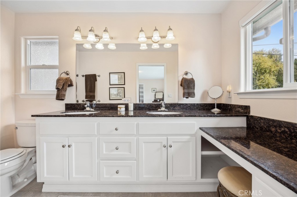 280 Kern Avenue Morro Bay, CA 93442 - Photo 28 of 54 a bathroom with a granite countertop sink a large mirror and vanity