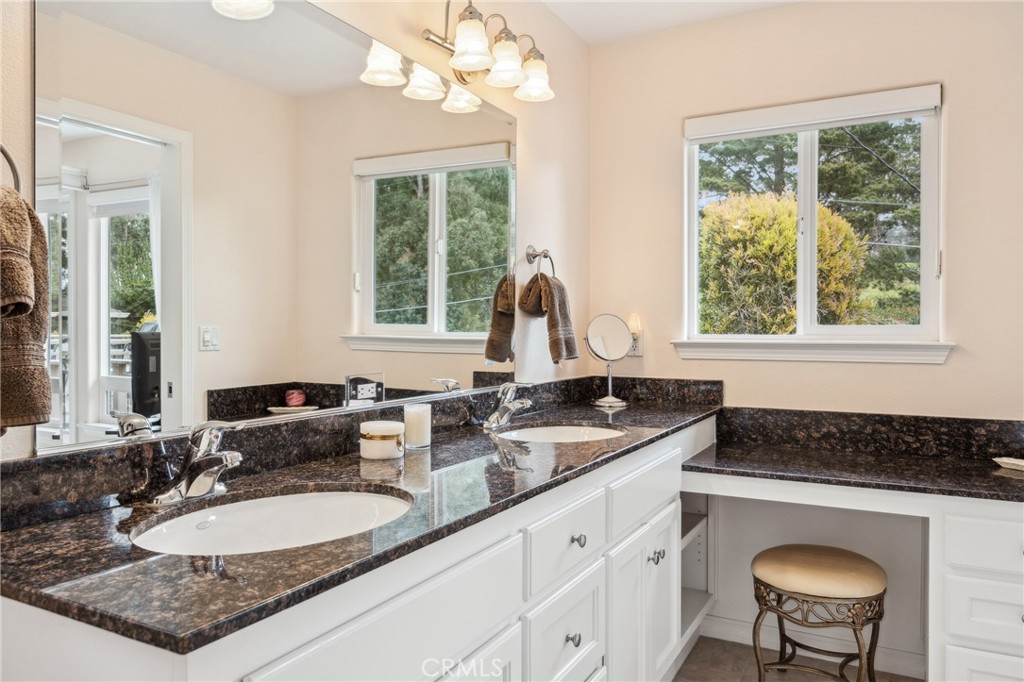 280 Kern Avenue Morro Bay, CA 93442 - Photo 30 of 54 a bathroom with a granite countertop sink and a mirror