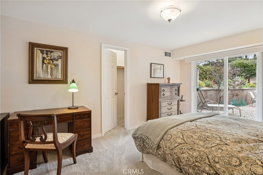 280 Kern Avenue Morro Bay, CA 93442 - Photo 33 of 54 a bedroom with a bed a chair and potted plant on the dresser