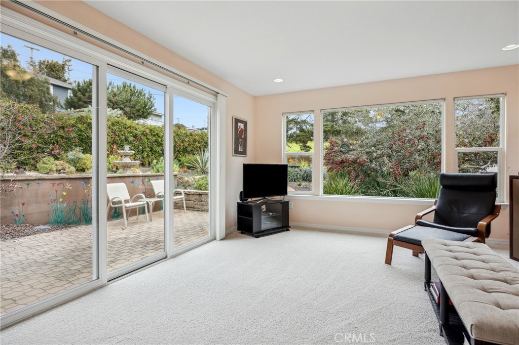 280 Kern Avenue Morro Bay, CA 93442 - Photo 37 of 54 a living room with furniture floor to ceiling window and a flat screen tv