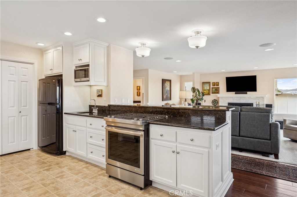 280 Kern Avenue Morro Bay, CA 93442 - Photo 8 of 54 a kitchen with stainless steel appliances kitchen island granite countertop a stove a sink and a refrigerator