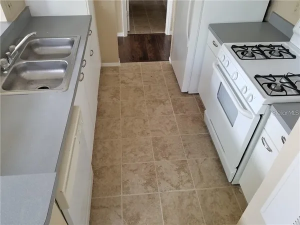 a bathroom with a sink a toilet a washer and dryer