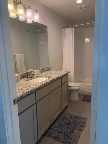 a kitchen with a sink cabinets and wooden floor