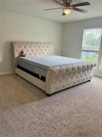 a view of a livingroom with furniture and a window