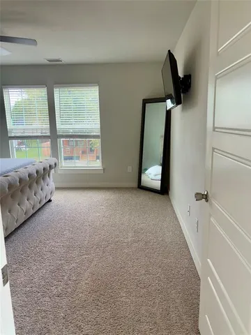 a view of a hallway to rooms