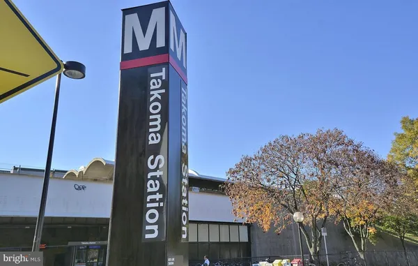 a view of street with shops on a street
