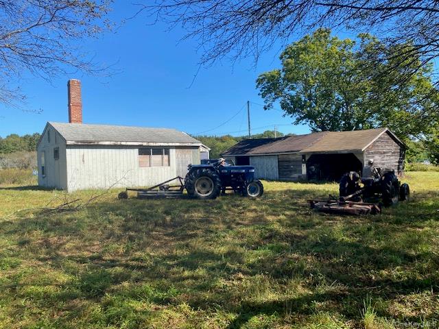 989 Highway 32 Wallkill, NY 12589 - Photo 2 of 37 a front view of a house with a yard