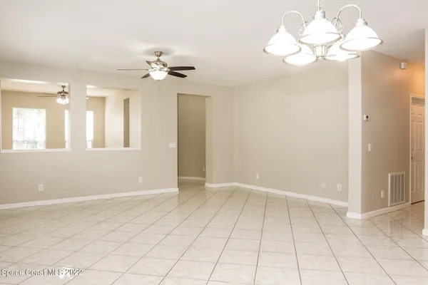 a view of kitchen with granite countertop cabinets and window