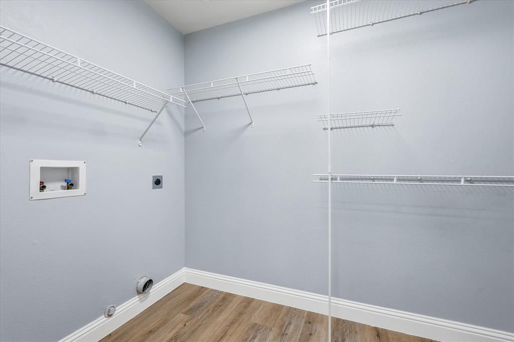 2616 Hollow Ridge Drive Denton, TX 76210 - Photo 23 of 31 Dedicated utility space featuring wood-finish flooring and light gray walls