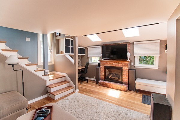 23 Massasoit Road Weymouth, MA 02191 - Photo 18 of 21 a living room with furniture a fireplace and a flat screen tv