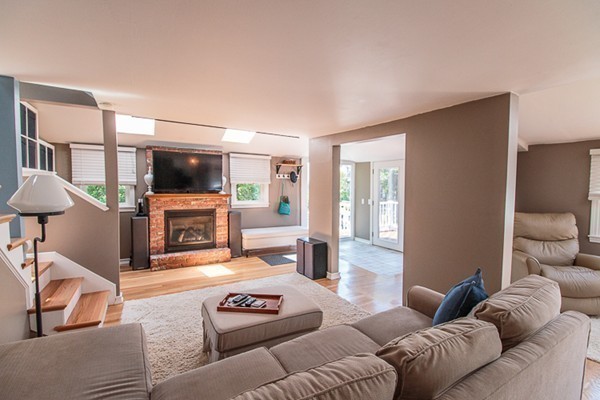 23 Massasoit Road Weymouth, MA 02191 - Photo 3 of 21 a living room with furniture a fireplace and a flat screen tv