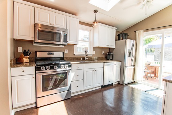 23 Massasoit Road Weymouth, MA 02191 - Photo 9 of 21 a kitchen with white cabinets stainless steel appliances and a window