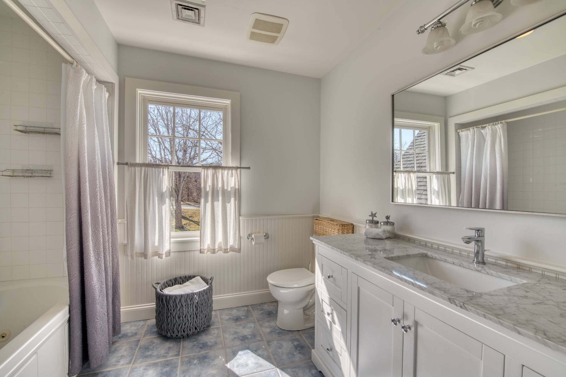 6 Wills Point Road Montauk, NY 11954 - Photo 10 of 16 a bathroom with a granite countertop sink a toilet and a window