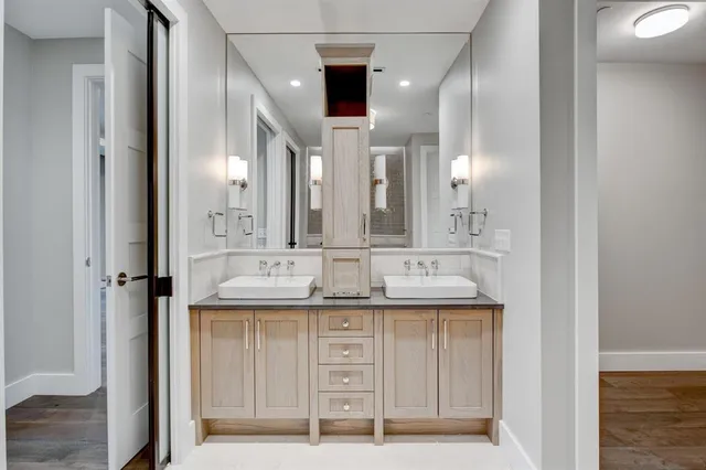 a bathroom with a double vanity sink and a mirror