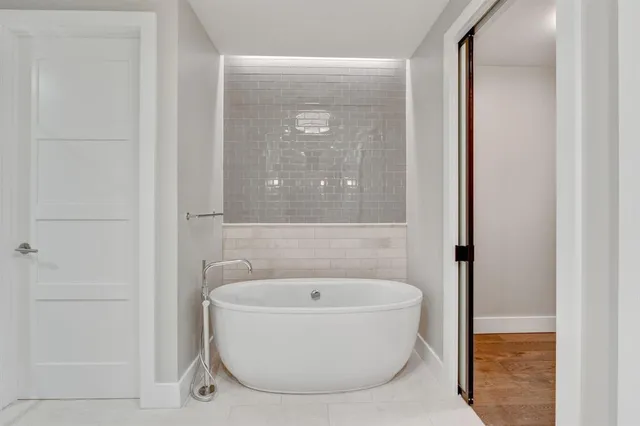 a bathroom with a tub and shower