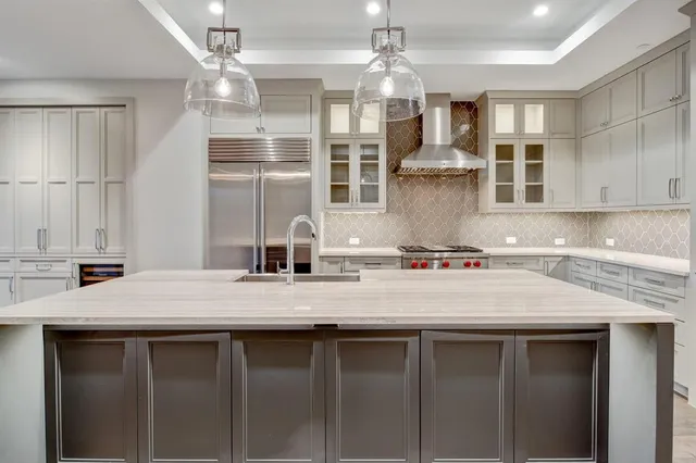 a kitchen with a sink a counter space and stainless steel appliances