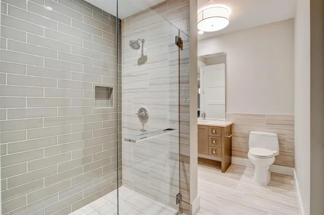 a bathroom with a toilet sink and shower