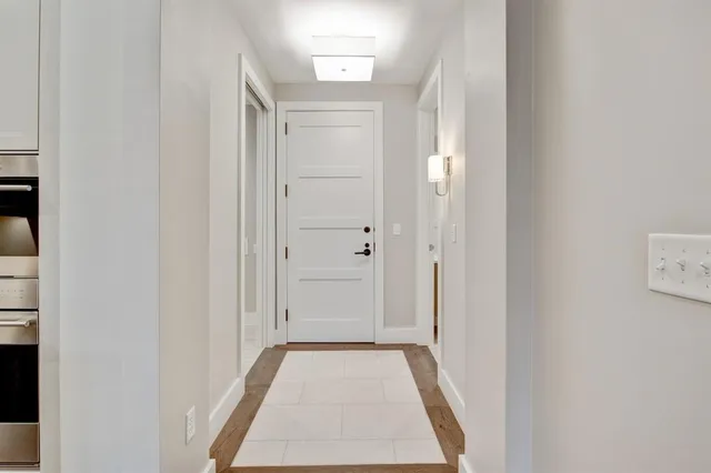 a view of a hallway with wooden floor