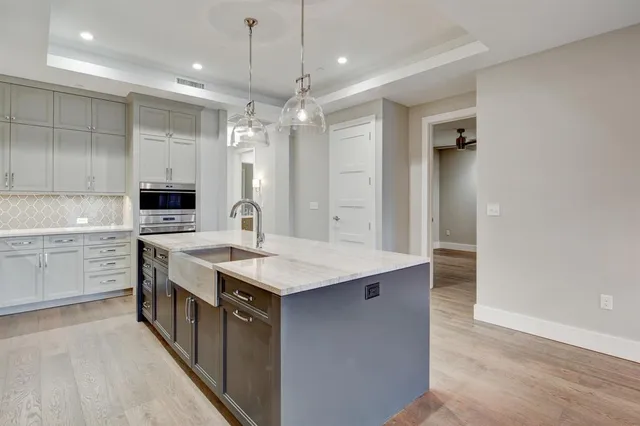 a kitchen with stainless steel appliances a sink and a refrigerator
