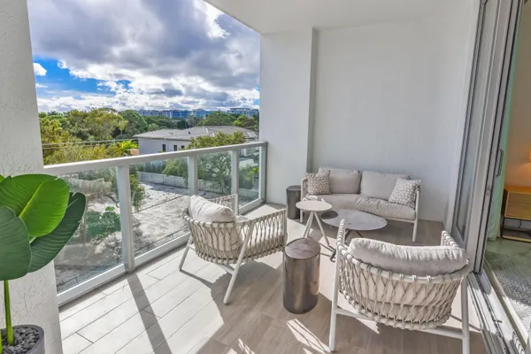 a bedroom with a large bed and wooden floor