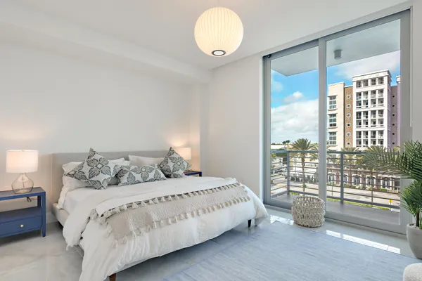 a living room with fireplace furniture and a large window