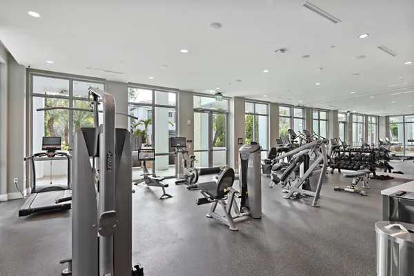a view of a patio with a table chairs potted plants and a yard