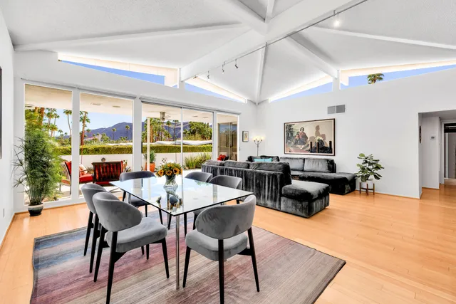a view of a dining room with furniture window and wooden floor