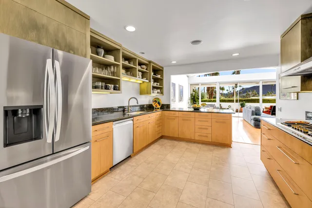 a large kitchen with stainless steel appliances and a refrigerator