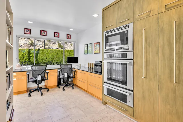 a view of a livingroom with workspace and a window