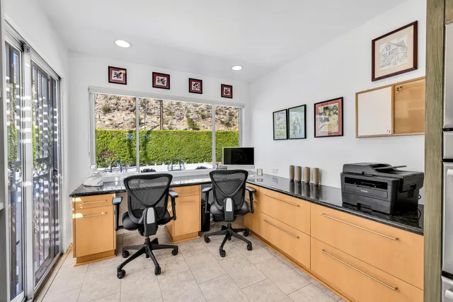 a view of a livingroom with workspace and a window