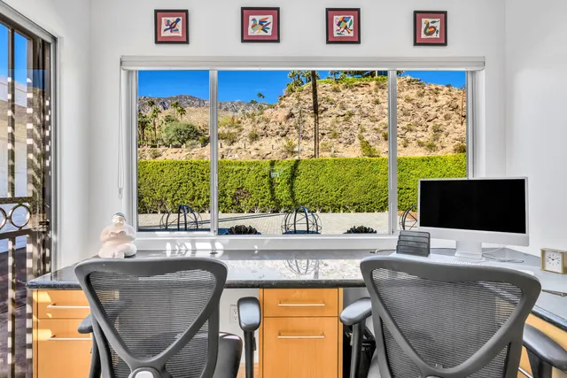 a dining room with a large window and table