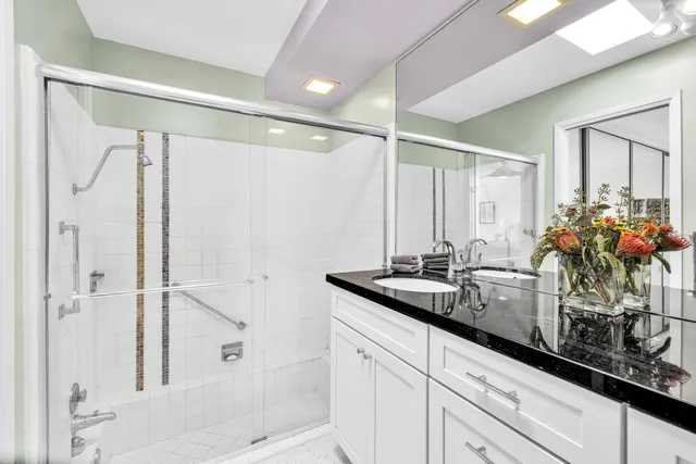 a bathroom with double sink and a mirror