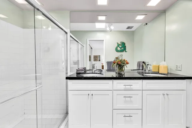 a bedroom with a large bed and a chandelier